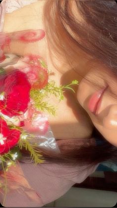 a woman with long hair and flowers in her hand