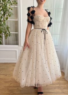 Step into the spotlight with this creamy-colored dress, beautifully constructed from high-quality tulle adorned with polka dot details. The fitted bodice features structured boning and artful draping that enhances your silhouette, while a romantic lace-up back and a flowing midi-length skirt provide a striking look with ample volume. Practical elements like inseam pockets merge convenience with style. Floral appliqué straps and a decorative ribbon bow belt add a touch of whimsy. Perfect for wedd Polka Dot Wedding Dress, A Line Prom Dresses, Polka Dot Wedding, Romantic Lace, Midi Length Skirts, Party Gowns, Embroidery Dress, Dot Dress, Polka Dot Dress