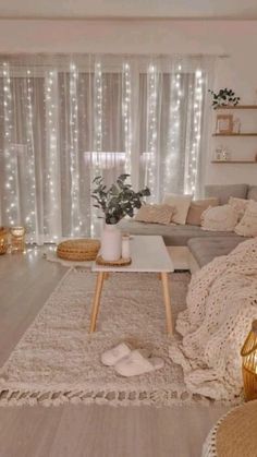 a living room filled with lots of furniture next to a large window covered in lights