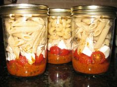 three mason jars filled with pasta and sauce