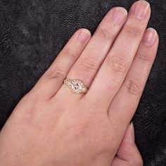 a woman's hand with a diamond ring on it