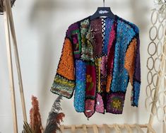 Step into a world of vibrant color and intricate design with our Multicolor Granny Square Crochet Cardigan. This floral, boho hippie-style sweater is the epitome of authentic handmade knitwear, perfect for the eco-conscious fashion lover. Our short Bohemian cardigan is a vintage-inspired hırka, lovingly crafted by skilled artisans. Each crochet jacket is a testament to the art of crochet, made with sustainable fashion knit practices in mind. Yarn 30% Wool, 70% Premium Acrylic Colorful Cardigan L Bohemian Crochet Long Sleeve Top One Size, Bohemian Multicolor Summer Sweater, Bohemian Long Sleeve Crochet Top For Spring, Hippie Crochet Top For Fall, Bohemian Crochet Top For Fall, Bohemian Long Sleeve Patchwork Sweater, Fitted Bohemian Crochet Top For Fall, Bohemian Fitted Long Sleeve Crochet Top, Hand Knitted Bohemian Crochet Top