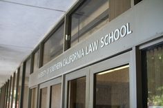 the california law school sign is on the side of a building that has glass doors