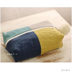 three pillows sitting on top of a wooden table