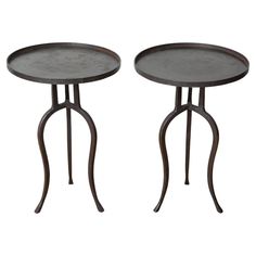 two tables with metal legs on each side and one has a round table in the middle