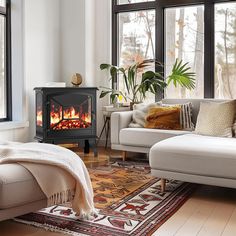 a living room filled with furniture and a fire place in the middle of the room