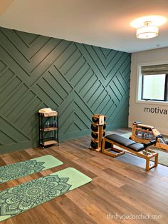 a yoga studio with wooden floors and green wall paneling in the background, there is a black leather chair next to an exercise mat