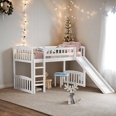 there is a white bunk bed with a slide in the corner and lights on the wall