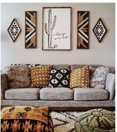 a living room filled with lots of furniture and pillows on top of carpeted flooring