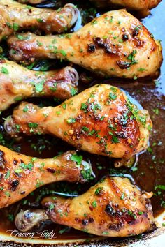 chicken legs covered in sauce and garnished with parsley