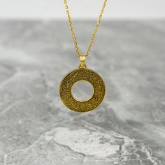 Crafted with meticulous attention to detail, the Ayatul Kursi Circle Necklace embodies elegance and symbolism in Islamic jewelry. This exquisite piece is made from high-quality sterling silver and features intricate Arabic calligraphy that showcases the powerful Ayatul Kursi verse from the Quran. The delicate circle design adds a touch of sophistication to this gold-plated pendant, making it a perfect gift for Muslim women seeking a blend of style and spirituality. The necklace exudes timeless beauty and serves as a reminder of faith and protection. Ideal for everyday wear or special occasions, this necklace is a meaningful accessory that resonates with its wearer on a deeper level. Celebrate your faith with this stunning Ayatul Kursi Circle Necklace that beautifully merges tradition with Symbolic Etched Jewelry For Blessing, Elegant Silver Necklaces For Blessings, Symbolic Round Necklace For Blessing, Elegant Silver Necklace For Blessing, Elegant Silver Necklace For Blessing Occasions, Spiritual Medallion Necklace With Filigree Details, Spiritual Medallion Necklace With Filigree, Spiritual Medallion Filigree Necklace, Spiritual Filigree Medallion Necklace