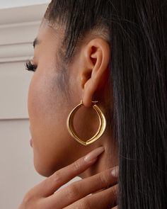 The Stella Hoop Earrings are bold chunky hoops with a modern, freeform shape and sharp edges that create a unique look. Despite their volume, they remain lightweight and comfortable thanks to our exclusive Italian electroforming technology. Crafted from sterling silver and plated with 18K yellow gold or white gold, each pair is hand-polished to perfection for a luxurious finish. Perfect as a gift for her, gift for mom, or best friend gift, these hoop earrings make a stylish statement. Closure: H Chic Chunky Hoop Jewelry, Chic Hoop Earrings With Ear Wire, Modern Chunky Hoop Earrings, Chic Hoop Wrap Earrings For Everyday, Chunky Hoop Jewelry, Trendy Chunky Hoop Jewelry, Modern Chunky Metal Earrings, Chic Chunky Hoop Earrings For Everyday, Modern Pierced Hoop Wrap Earrings