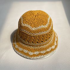 Knitted Beach Hat Made Of Yarn, Brown Crochet Hat For Summer, Crochet Straw Bucket Hat With Short Brim, Brown Outdoor Crochet Hat, Outdoor Curved Brim Crochet Hat, Cotton Yarn Cap, Yellow Knitted Beach Hat, Straw Crochet Hat With Short Brim For Outdoor, Beige Crochet Hat For The Beach