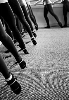 a row of women in tight stockings and high heels