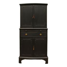 an old fashioned black cabinet with brass handles