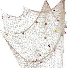 there is a large net that has many balls in it and some strings hanging from the ceiling