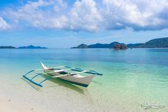 two boats are tied up on the beach