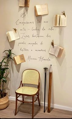 a chair and some books hanging on the wall next to a potted palm tree