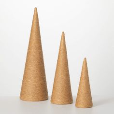 three wooden cones sitting next to each other