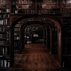 an old library with lots of books on the shelves and wooden floors, all lined up in rows