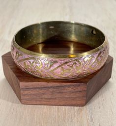 "High-quality brass vintage brass bracelet, perfect for summer festival wear.  This bracelet features a lovely inlaid pink floral/heart design. Embrace your bohemian spirit with this bold and chunky cuff.   This bracelet will comfortably fit a 6 3/4\" to 7 1/4\" wrist The width of the bracelet at the widest point is 3/4\" The inside circumference measures 8\" Condition: Great vintage condition, moderate signs of wear" Pink Metal Bracelets For Wedding, Traditional Adjustable Pink Bangle, Vintage Brass Bracelets For Festivals, Bohemian Antique Gold Bracelets For Gift, Pink Brass Jewelry For Wedding, Adjustable Pink Metal Bangle, Pink Brass Wedding Jewelry, Vintage Pink Jewelry For Festivals, Pink Bohemian Jewelry For Festivals