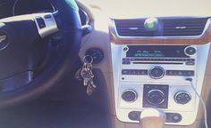 the interior of a car with a key chain hanging from it's center console