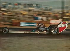 a man driving a race car on top of a track