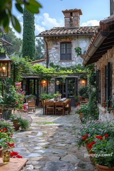 an outdoor dining area with potted plants and flowers on either side of the patio