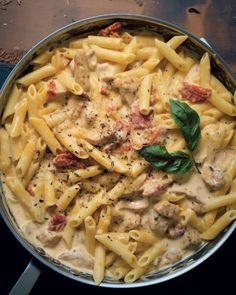 a pan filled with pasta and sauce on top of a table