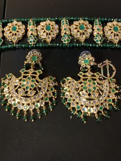 Ready to ship choker with earrings width of choker 1 inch length of choker 9 inch Length of earrings 2.5 inch width 2 inch made using onyx green beads with cz polki and 22ct gold plating delivered in 3-5 days within USA Traditional Green Jeweled Jewelry, Festive Green Stone Work Jewelry, Green Hand Set Chandbalis For Festivals, Green Hand Set Chandbalis For Diwali, Festival Green Hand Set Chandbalis, Festive Green Kundan Jewelry, Green Chandbali Jewelry For Diwali, Heavy Green Kundan Jewelry, Green Bollywood Style Hand Set Chandbalis