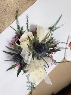 a bouquet of flowers sitting on top of a white table next to a pair of scissors