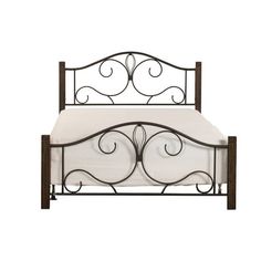 an iron bed frame with white sheets and pillows on it, against a white background