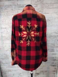 a red and black flannel shirt on a mannequin head