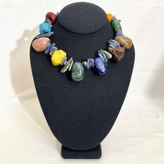 A rich combination of shapes, colors, and textures.  The necklace displays the beauty of different natural stones.  A simple organic beaded necklace with Agate, Kyanite, Wood, Sodalite, Rhodonite, Unakite, Boxwood Lotus Pod, and Dragon Bloodstones. Chunky Stone Necklace, Necklace Displays, Lotus Pods, Lotus Necklace, Simple Organic, Beaded Choker Necklace, Colourful Necklace, Beaded Choker, Collar Necklace