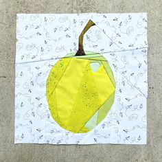 a piece of paper that has been cut into an apple on top of the fabric