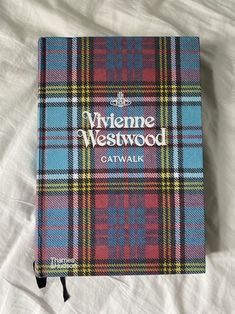 a book that is laying on top of a white sheet with the words wayne westwood catwalk