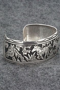 This expertly crafted sterling silver bracelet featuring horses was made by Navajo silversmith Richard Singer. The back is signed R Singer and stamped .925.Size: 5 5/8" (will fit up to a 6 3/4" wrist)Gap: 1 1/8"Width: 1"Free shipping on all orders! We ship with USPS and always include tracking. All orders ship within a day of payment.Returns are accepted up to 30 days after you receive your order. Just send us a message. Our shop offers cash back or store credit. The item must be returned in new Southwestern Engraved Silver Cuff Bracelet, Southwestern Silver Cuff Bracelet With Inlay, Southwestern Style Nickel-free Bangle, Nickel-free Southwestern Bangle Cuff Bracelet, Southwestern Silver Hand-strung Bracelets, Sterling Silver Bracelet, Native American Jewelry, Free Jewelry, Sterling Silver Bracelets