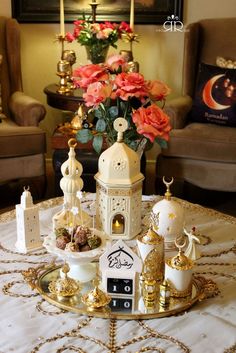 a table topped with lots of gold and white items on top of a golden tray