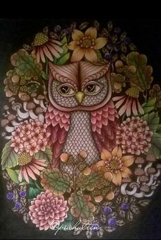 an owl is sitting in the middle of some flowers and leaves on a black background