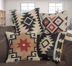 two decorative pillows sitting on top of a couch