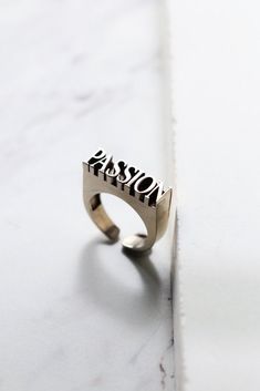 "THE Word on Ring \"PASSION\" original made and designed by Defy The jewelry is designed to have unique style and beautiful details. - The dimensions are ; approx. 0.6 x 2.3 x 0.6 cm. - The Ring size is adjustable between 6-9.5 US.**Please choose options below.** - Material : brass / silver **Free Shipping to World Wide** - Please allow us to prepare the item and parcel between 3-5 working days (*Between 5-7 working days For Sterling Silver 925*) - All items will be sent by Thai Registered Airma Graffiti Jewelry, Word Ring, Dark Style, Jewelry Words, Letter Ring, Skull Jewelry, Diy Rings, Skull Ring, Style Accessories