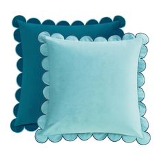 two blue pillows with scalloped edges