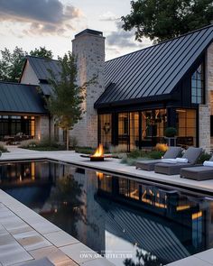 a house with a pool in front of it at sunset or sunrise time, and an outdoor lounge area next to the pool