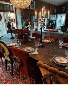 a dining room table with plates and place settings