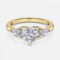 three stone heart shaped diamond ring in yellow gold