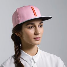 The Blinky is a classic six-panel, baseball-style cap in pink with a contrasting light blue brim and raised embroidery detail in orange. All March Caps feature top eyelets and an adjustable snap-back closure. Each cap comes with a hand-numbered card signed by the designer. Trendy Pink Flat Cap, Pink Adjustable Flat Bill Snapback Hat, Pink Fitted Hat With Flat Brim, Pink Adjustable Flat Cap, Adjustable Pink Flat Cap, Pink Visor Snapback Hat For Spring, Pink Snapback Visor Hat For Spring, Pink Flat Bill Sports Hat, Trendy Pink Snapback Hat With Visor