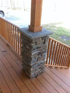 a stone pillar sitting on top of a wooden deck