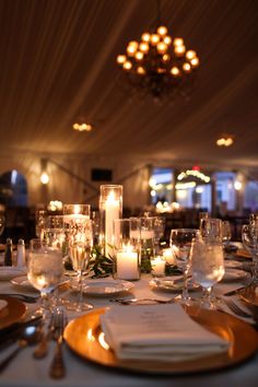 the table is set with candles and place settings