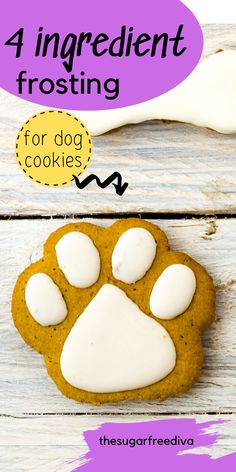 a cookie with white frosting on top and an image of a dog's paw