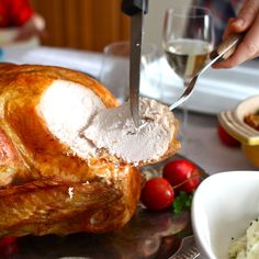 a turkey being cut with a knife and fork